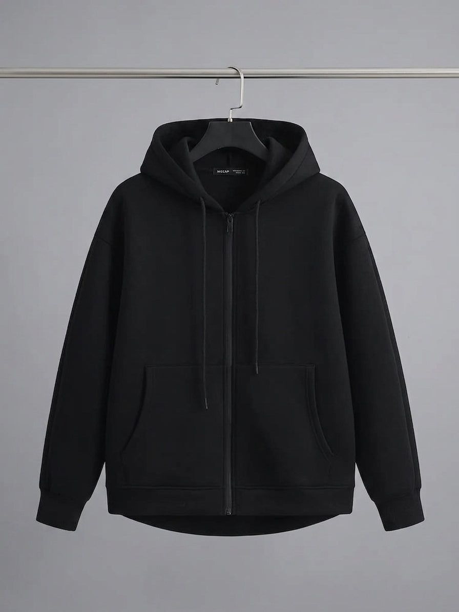 A black zip-up hoodie with a drawstring hood and front kangaroo pockets, hanging on a black hanger against a solid gray background.