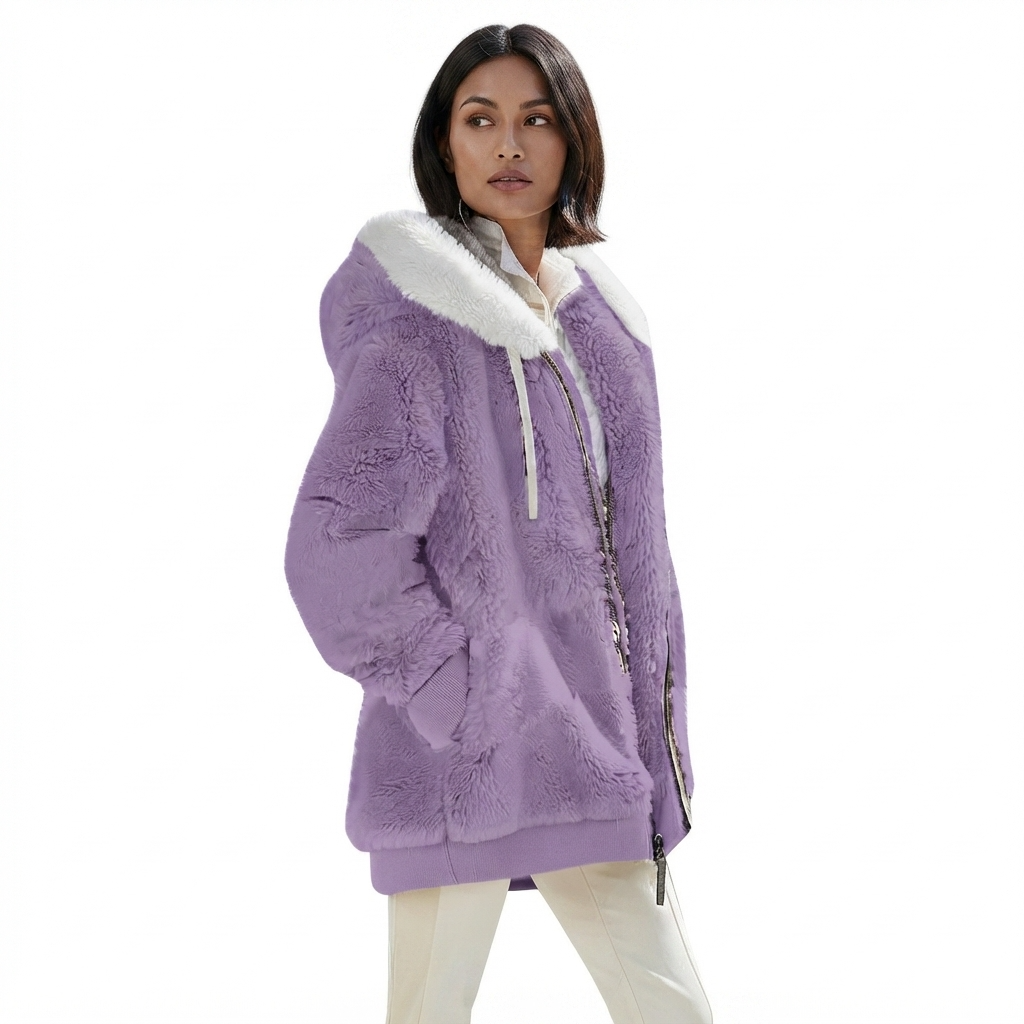 A woman wearing a lavender purple sherpa fleece hooded jacket with a white faux-fur trimmed hood and white drawstrings, paired with white pants, against a plain white background.