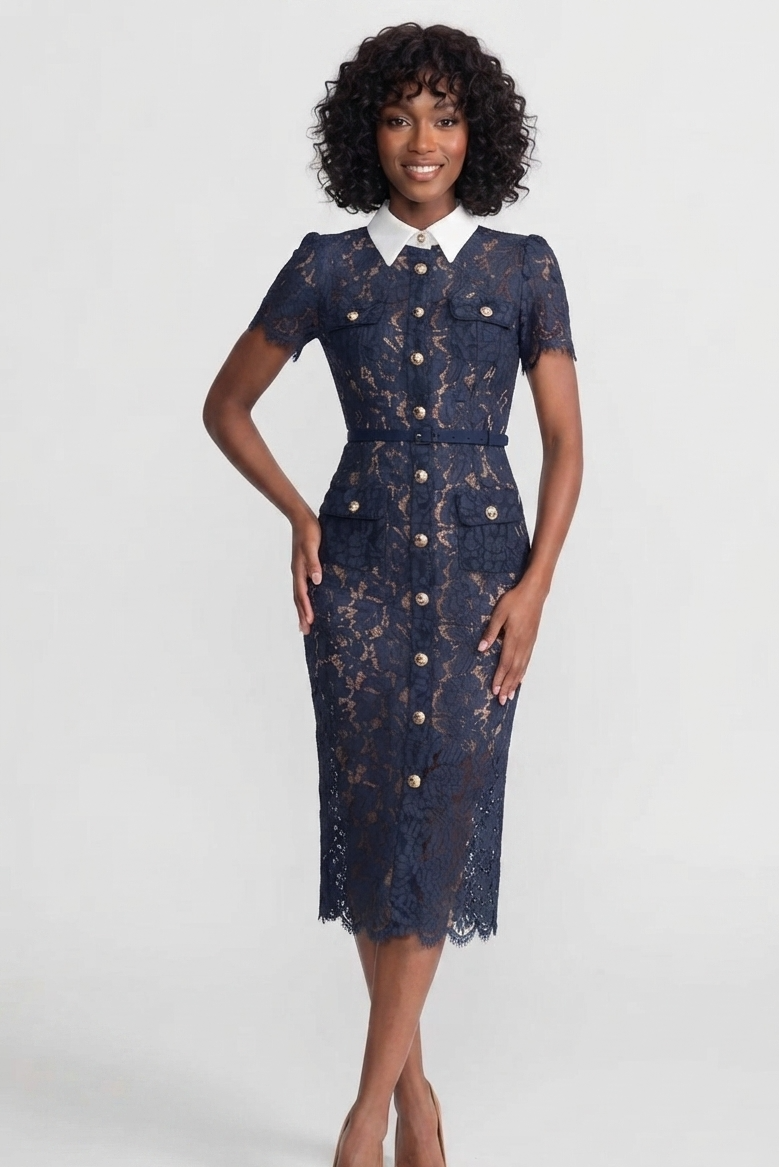 A woman modeling a navy blue lace midi dress with a white pointed collar and gold-tone buttons, set against a plain light gray studio background.