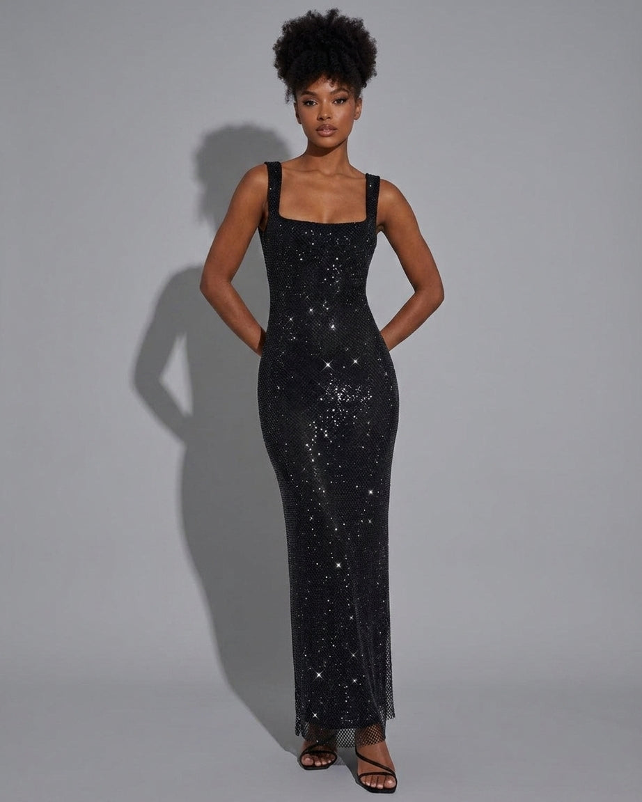 A woman modeling a floor-length black sequined gown with a square neckline and wide shoulder straps, standing against a light gray studio background.