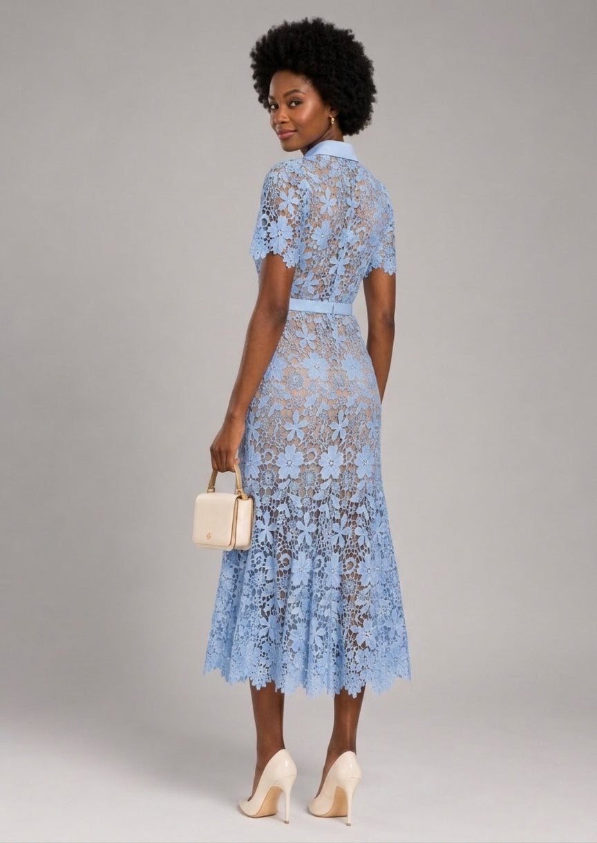 A woman modeling a light blue lace midi dress with short sleeves, a high collar, and a matching waist belt, shown from the back against a neutral gray studio background.