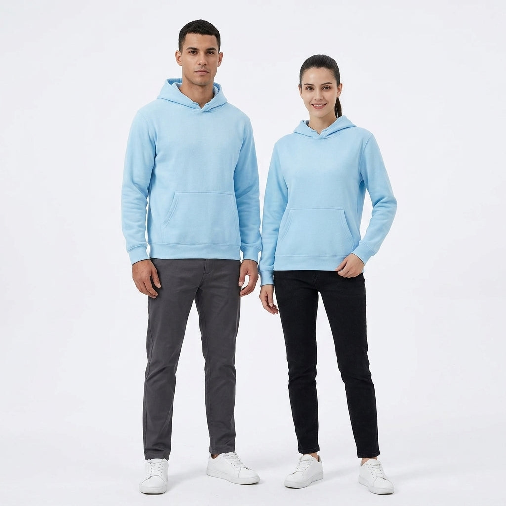 A man and a woman modeling matching light blue pullover hoodies, standing against a plain white studio background.