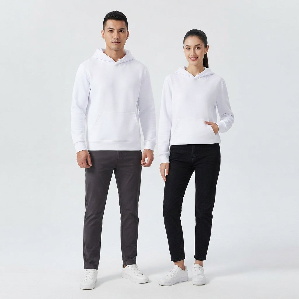 A man and a woman modeling matching white hooded sweatshirts, with the man wearing dark gray pants and the woman wearing black pants, standing against a light gray studio background.