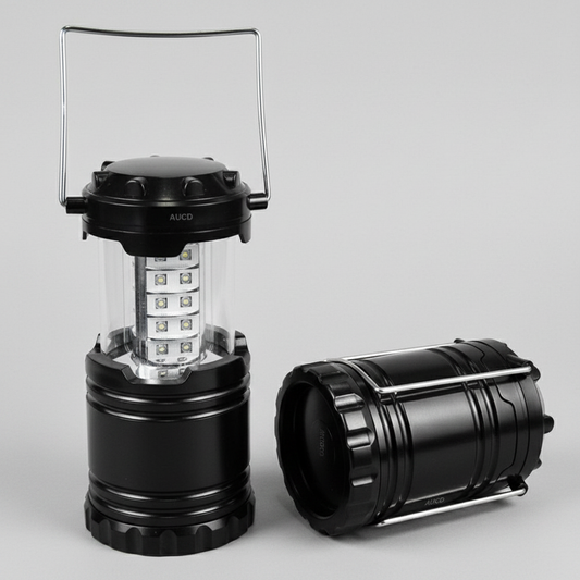 Black camping lantern with a clear cover on a gray background