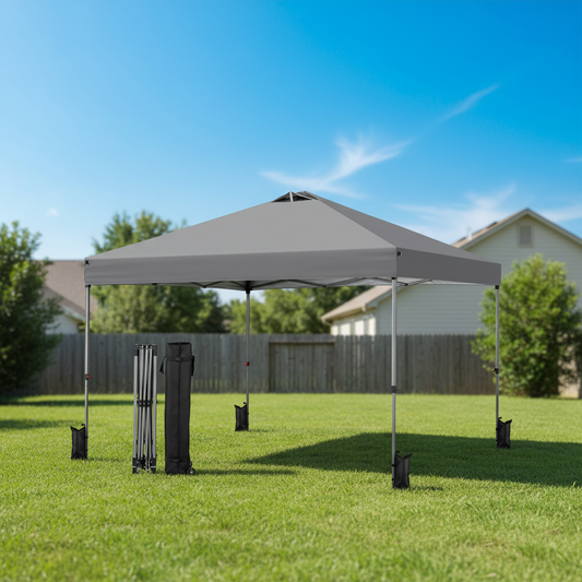 Gray outdoor canopy tent set up on a grassy area with a clear blue sky.