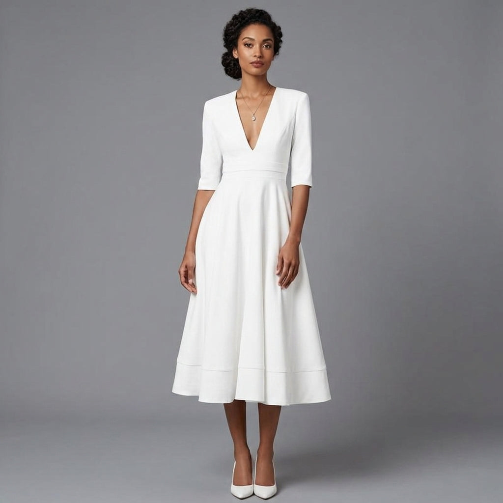A woman modeling a white midi dress with a deep V-neckline, elbow-length sleeves, and a flared skirt against a solid gray studio background.