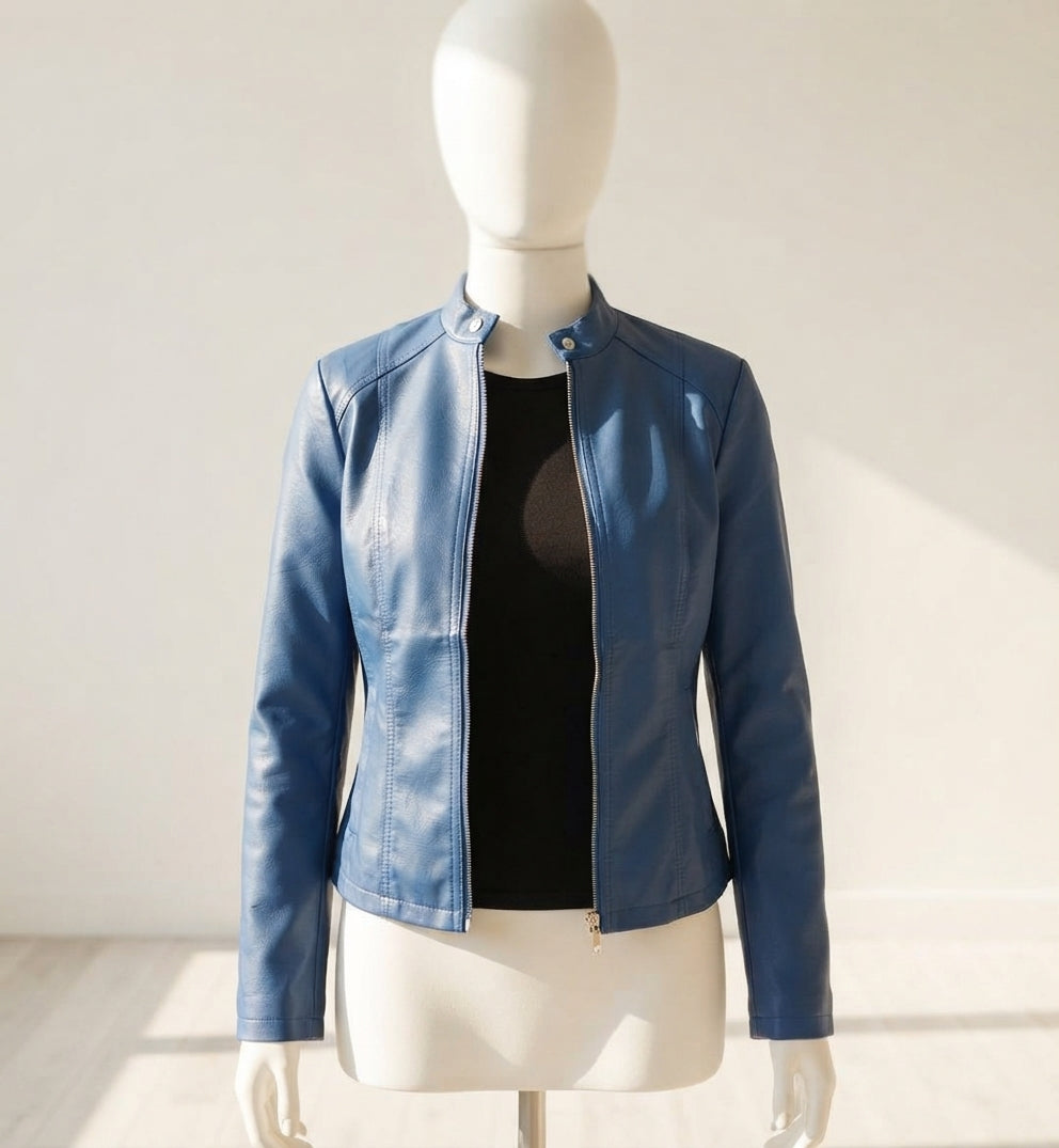 A blue faux leather jacket displayed on a white mannequin torso, layered over a black top, set against a neutral light beige background.