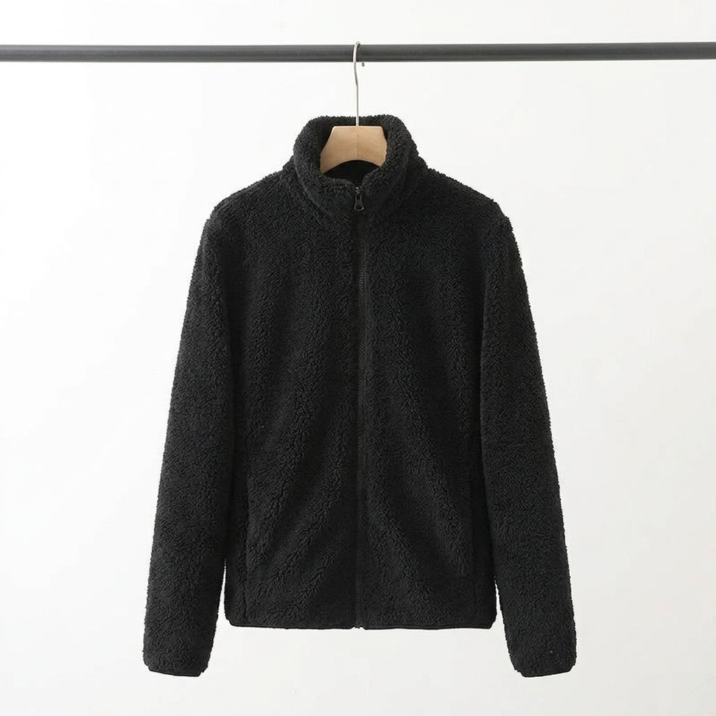 A black sherpa fleece zip-up jacket with a mock neck collar, hanging on a wooden hanger from a black clothing rack against a plain white background.