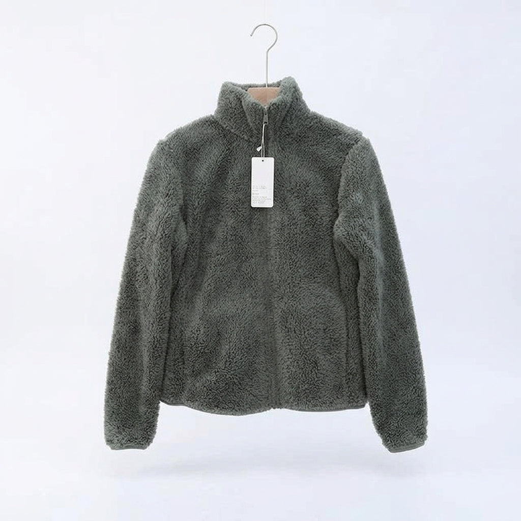 A dark gray fuzzy fleece zip-up jacket hanging on a wooden hanger against a plain white background.