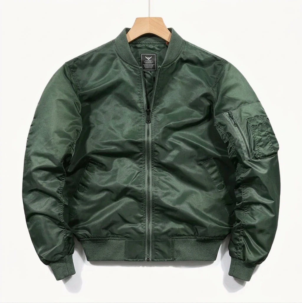 A dark green nylon bomber jacket hanging on a wooden hanger against a plain white background.