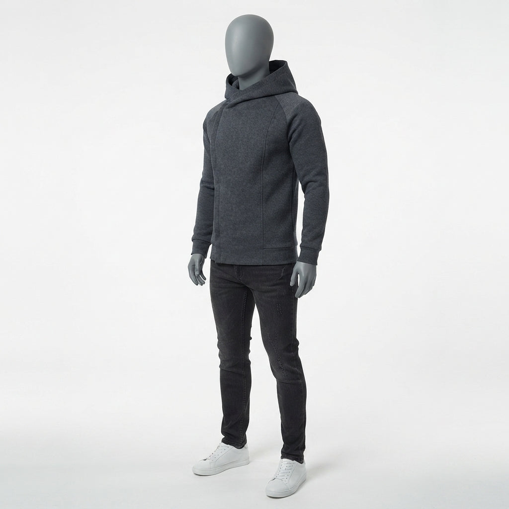 A dark gray heathered pullover hoodie with contrasting dark gray shoulder panels, shown on a gray mannequin wearing black pants and white sneakers against a light gray studio background.
