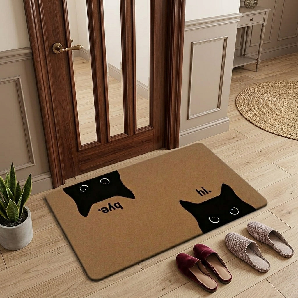 Doormat with black cat designs and text on a wooden floor in a home setting.